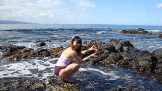 Zeng plays in a tide pool formed  by lava from the volcano Haleakula. Maui was formed by seafloor volcanic eruptions 5 million years ago